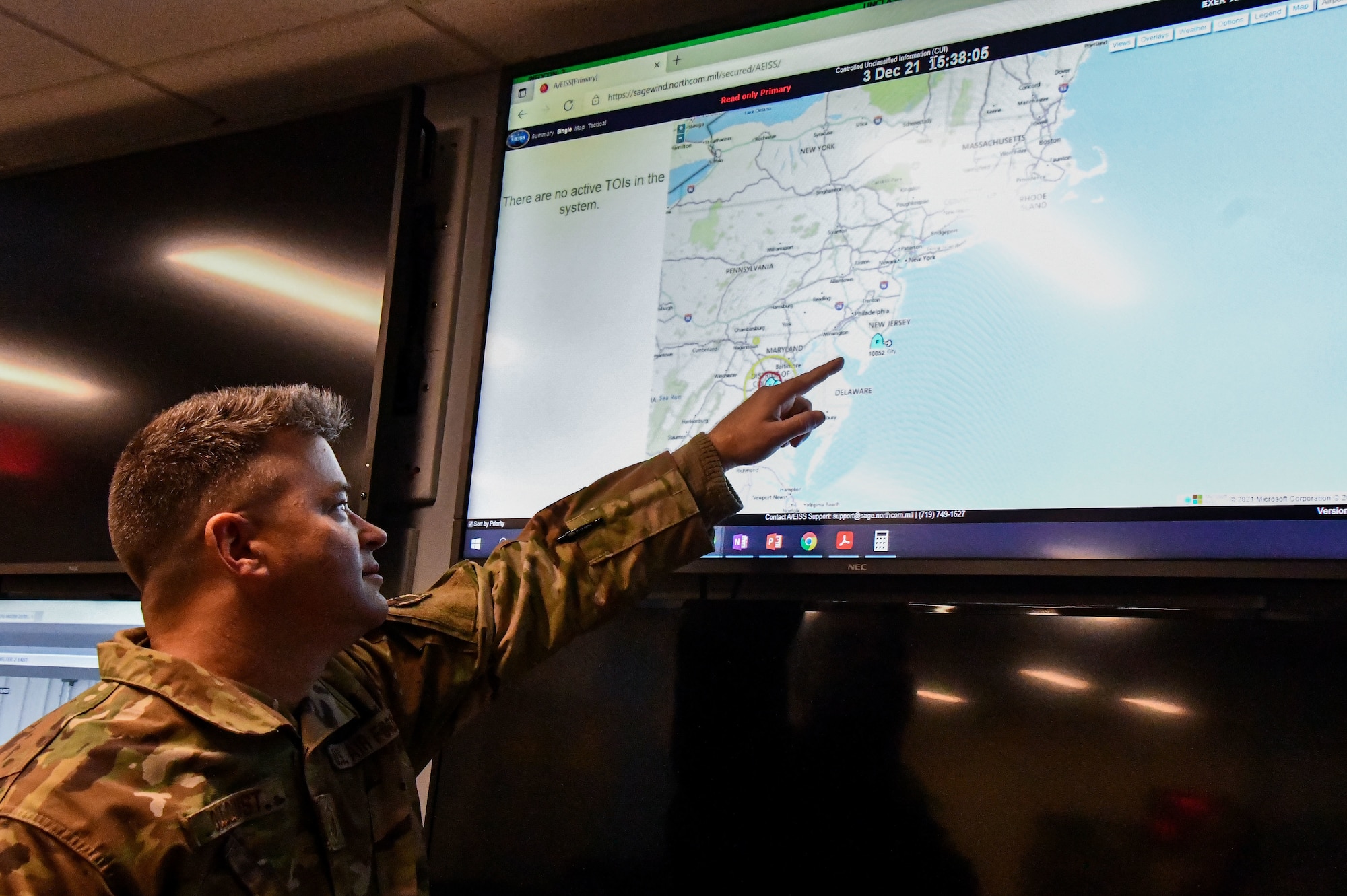Master Sgt. Robert Ollquist, 104th Fighter Wing command post Non-commissioned Officer in Charge, executes mission requirements December 3, 2021, at Barnes Air National Guard Base, Massachusetts. The command post is responsible for receiving and dispersing all information coming onto or leaving Barnes ANGB.  (U.S. Air National Guard photo by Staff Sgt. Sara Kolinski)