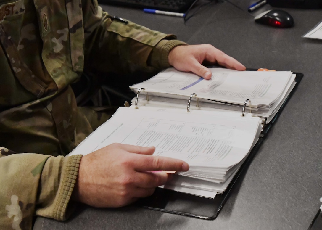 Airmen from the 104th Fighter Wing command post execute mission requirements December 3, 2021, at Barnes Air National Guard Base, Massachusetts. The command post is responsible for receiving and dispersing all information coming onto or leaving Barnes ANGB.  (U.S. Air National Guard photo by Staff Sgt. Sara Kolinski)