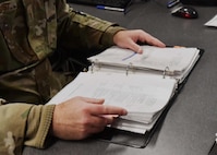 Airmen from the 104th Fighter Wing command post execute mission requirements December 3, 2021, at Barnes Air National Guard Base, Massachusetts. The command post is responsible for receiving and dispersing all information coming onto or leaving Barnes ANGB.  (U.S. Air National Guard photo by Staff Sgt. Sara Kolinski)