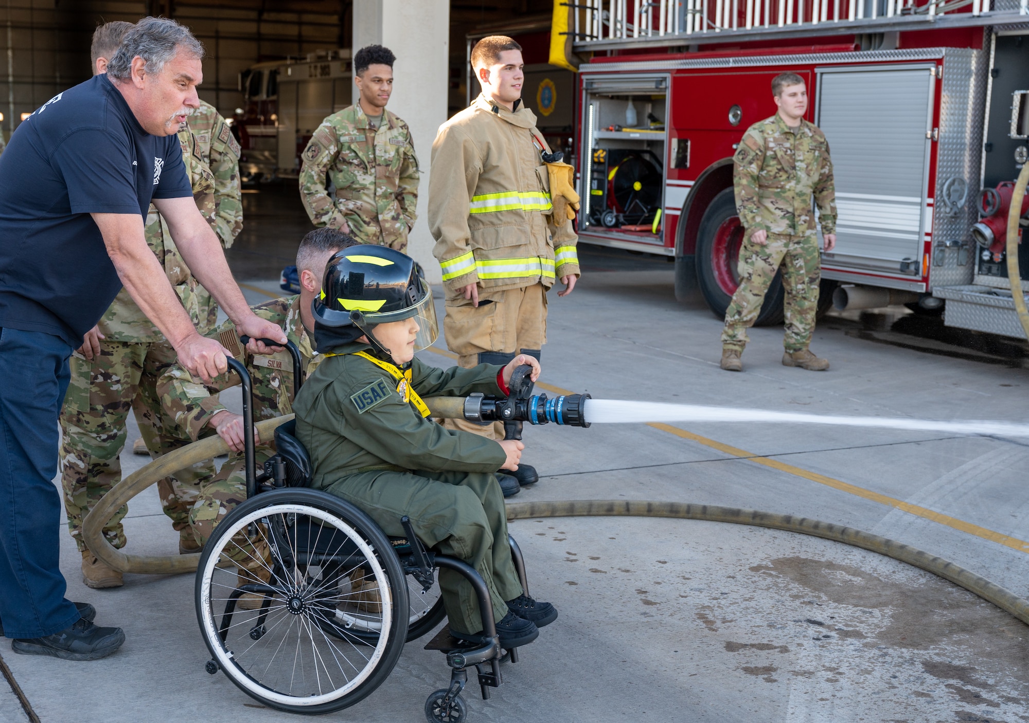Anthony ‘Baby Yoda’ Ramos, Pilot for a Day participant, sprays a firehose Dec 16, 2021, at Luke Air Force Base, Arizona.