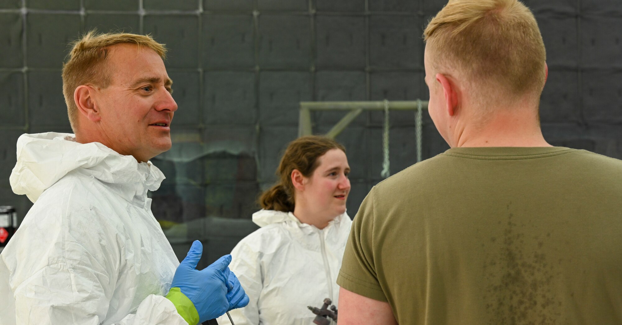 Col. Tom Preston, 49th Maintenance Group commander, talks with 49th Equipment Maintenance Squadron Airmen after painting the new 49th MXG flagship, Dec. 9, 2021, on Holloman Air Force base, New Mexico. This flagship will be one of five located on Holloman Air Force Base. (U.S. Air Force photo by Airman 1st Class Adrian Salazar)