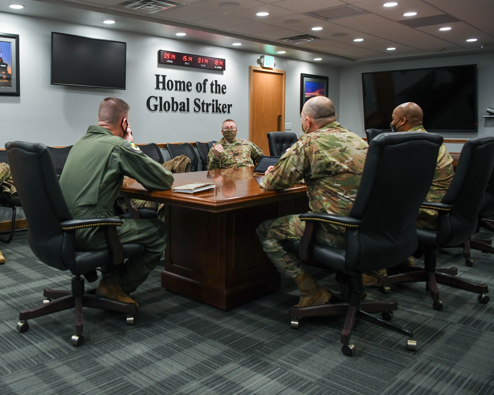 Staff Sgt Banta sits around a conference room table with 5th Bomb Wing leadership