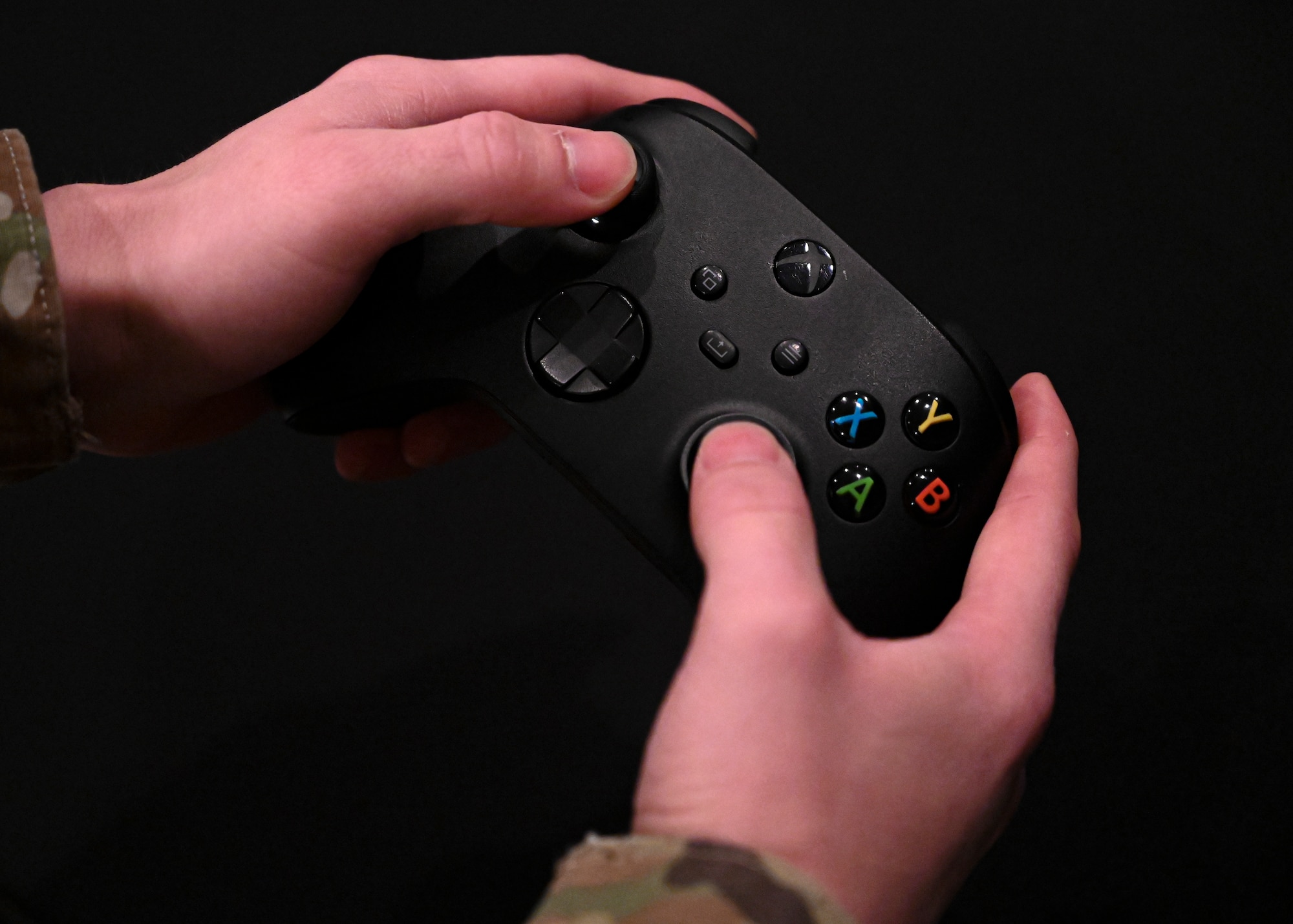 Senior Airman Isaac Garcia, 308th Aircraft Maintenance Unit assistant dedicated crew chief, handles his controller Dec. 14, 2021 at Luke Air Force Base, Arizona. Dupont is part of team “Joint Strike Fighters,” which participated in the Department of the Air Force Gaming League’s Apex Legends Tournament held throughout the  Air Force and its sister services. (U.S. Air Force photo by Senior Airman David Busby.)