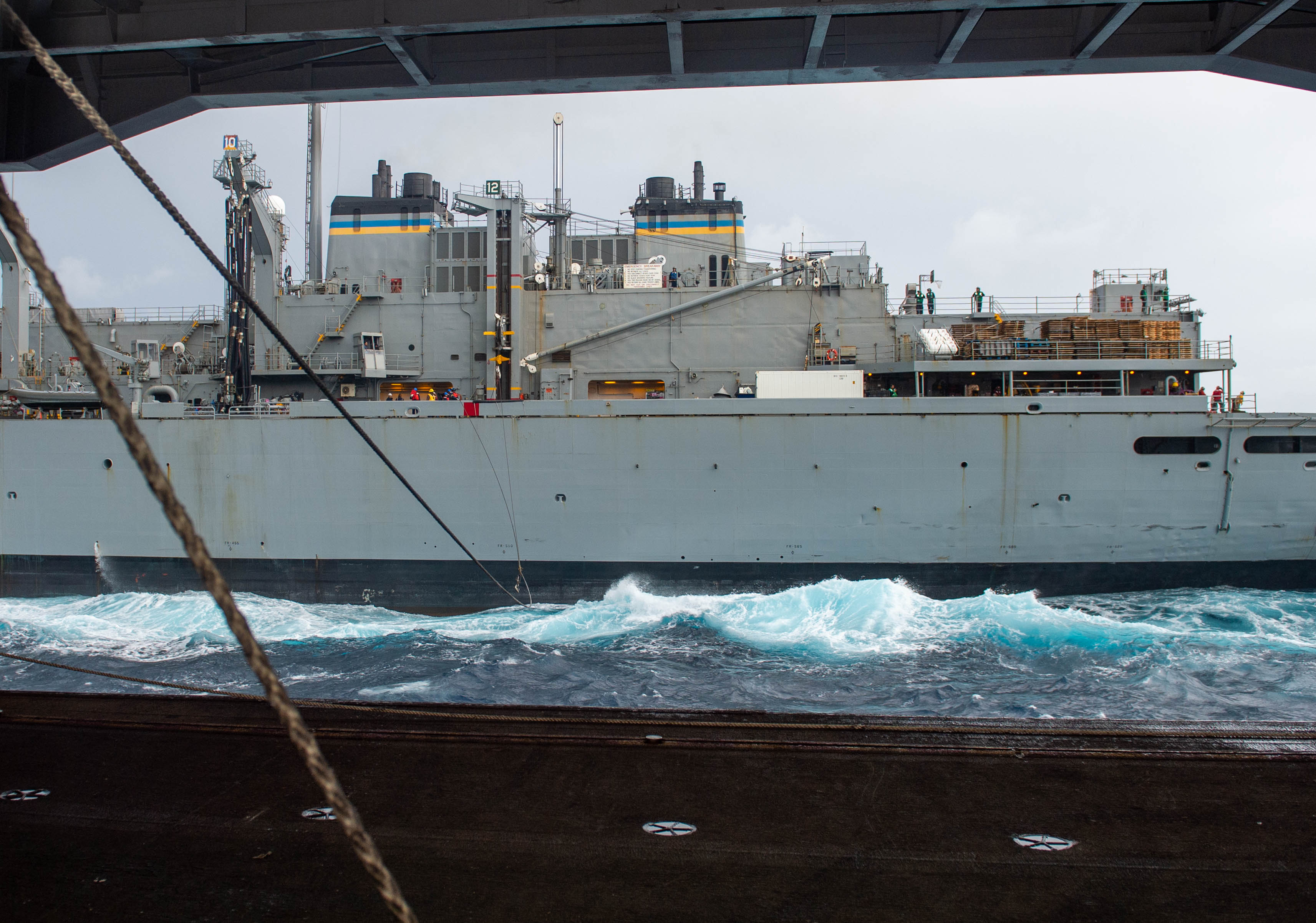 The fast combat support ship USNS Supply (T-AOE 6) transits alongside the Nimitz-class aircraft carrier USS Harry S. Truman (CVN 75) during a replinishment-at-sea, Dec. 28, 2021.