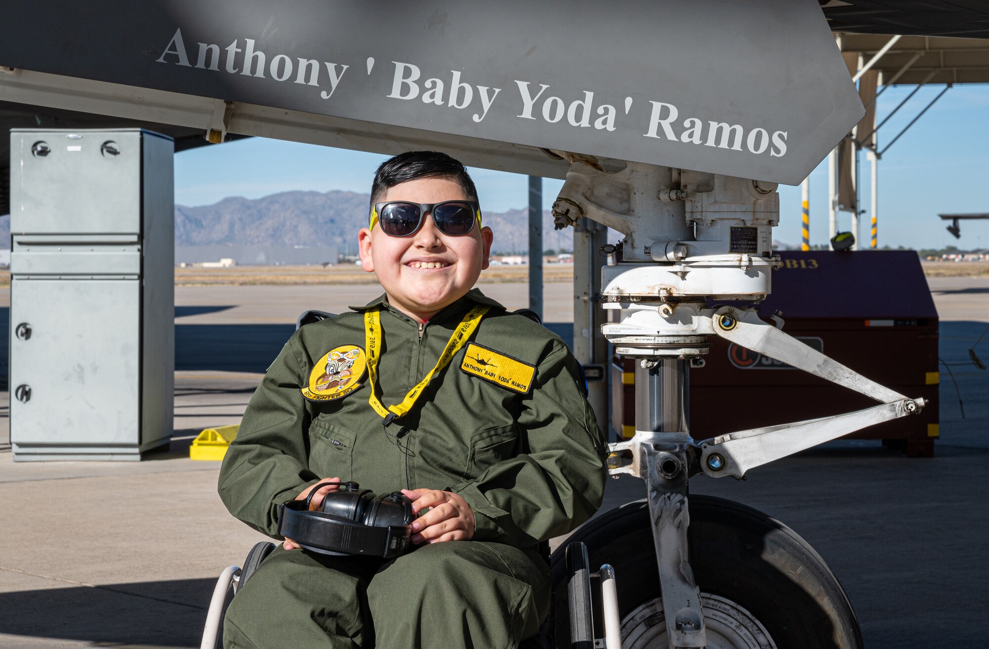 Anthony ‘Baby Yoda’ Ramos, Pilot for a Day participant, sits in front of an F-35 Lightning II Dec. 16, 2021, at Luke Air Force Base, Arizona.