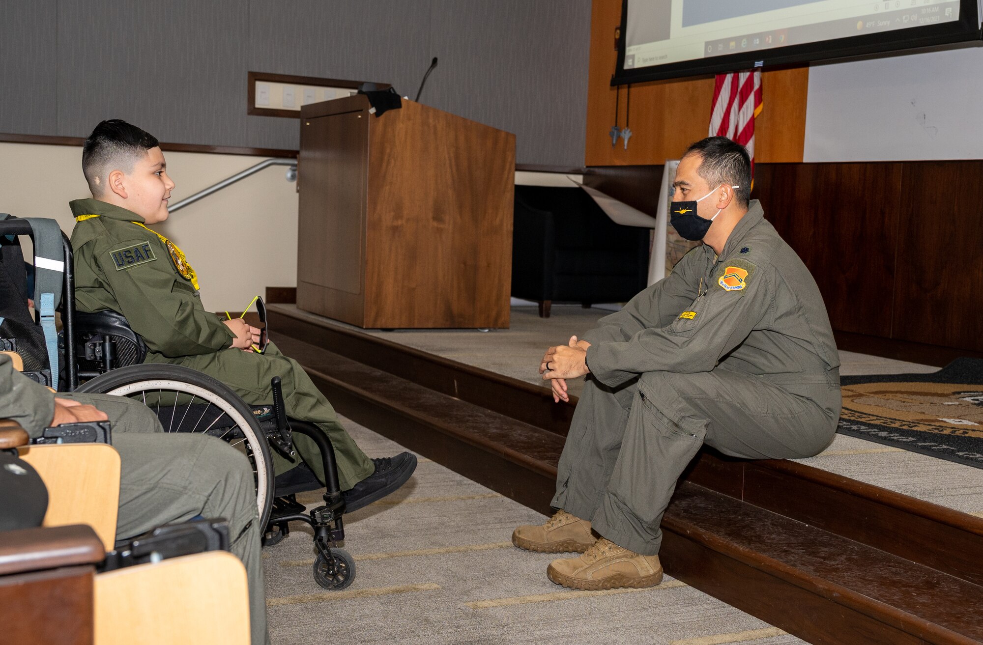 Anthony ‘Baby Yoda’ Ramos, Pilot for a Day participant, speaks with Lt. Col. Christopher Leong, 61st Fighter Squadron commander, Dec 16, 2021, at Luke Air Force Base, Arizona.