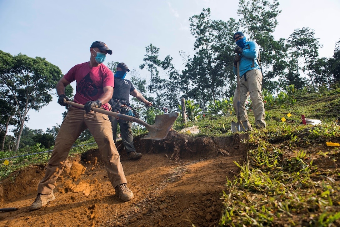 Members of a Defense POW/MIA Accounting Agency (DPAA) recovery team dig in an excavation unit during a DPAA recovery mission in Quang Nam Province, Vietnam. DPAA’s mission is to achieve the fullest possible accounting for missing and unaccounted-for U.S. personnel to their families and the nation. (U.S. Air Force photo by Staff Sgt. Jonathan McElderry)