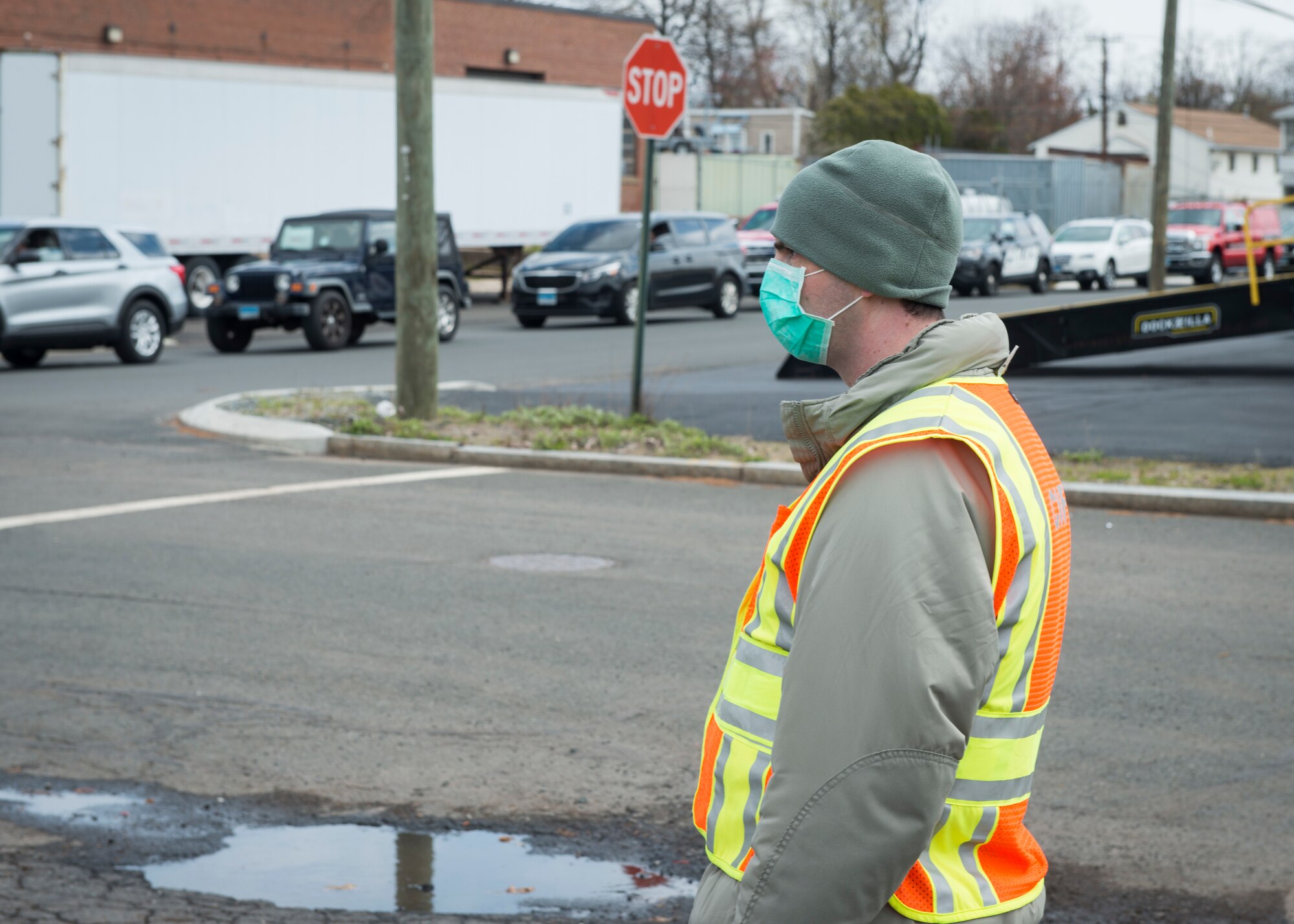 U.S. Air Force Staff Sgt. Nathan Pisani, 103rd Logistics Readiness Squadron air transportation specialist, helps direct traffic at a PPE distribution site in West Hartford, Connecticut, April 22, 2020. The Connecticut National Guard is supporting the Connecticut Department of Public Health in distributing items including masks, gloves, and face shields to assisted living facilities, residential care homes, long-term care facilities, and first responders. (U.S. Air National Guard photo by Staff Sgt. Steven Tucker)