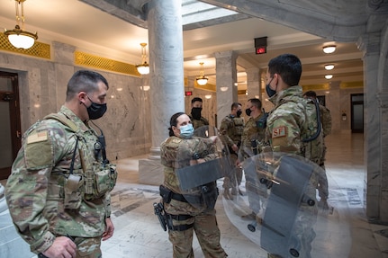 Staff Sgt. Weeks, Tech Sgt. Tracy and Airman Rayos from the 151st Security Forces Squadron, Utah Air National Guard practice shield techniques Jan 16, 2021 at the Utah State Capitol.