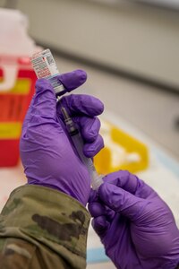 A Soldier, with the Utah National Guard Medical Detachment, prepares a COVID-19 vaccine