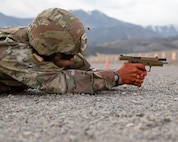 Soldier shoots pistol from prone position