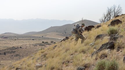 Soldier climbs hill