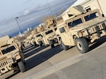 Colorado National Guard High Mobility Multipurpose Wheeled Vehicles or Humvees, stage at the Denver Armory, Denver to support the Boulder County Sheriff with traffic control, security operations, and evacuation of displaced citizens from the areas affected by the Marshall Fire in Boulder County, Colorado Dec. 31, 2021. Gov. Jared Polis declared a state of emergency which authorized the use of unarmed CONG assets for law enforcement purposes supporting direct consequences of this event. (Stock photo)