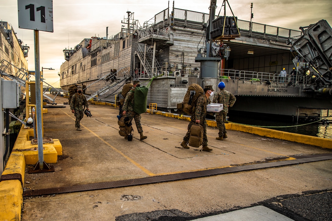 U.S. Marines with Special Purpose Marine Air-Ground Task Force - Southern Command unload gear from the Spearhead-class USNS Burlington (T-EPF 10) at Joint Expeditionary Base Little Creek-Fort Story, Virginia, Dec. 28, 2020