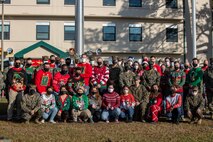 U.S. Marines from Marine Aircraft Group 26 pose for a photo with the Commander’s Cup at the MAG-26 headquarters building on Marine Corps Air Station New River, Dec. 18, 2020. Units competed in a series of different sporting events and tournaments, each winning unit was awarded with a Commanders’ Cup trophy and monetary compensation in the form of unit and Family Readiness funds. (U.S. Marine Corps Photo by Lance Cpl. Isaiah Gomez)