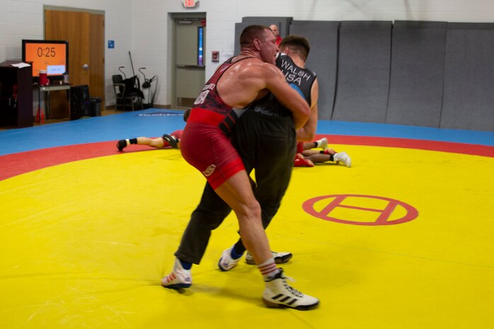 U.S. Marine Corps Staff Sgt. John Stefanowicz, left, and Capt. Peyton Walsh, right, with the All-Marine Wrestling Team (AMWT), hone their wrestling techniques to prepare for the Olympic Trials, on Marine Corps Air Station New River, North Carolina, Jan. 8, 2021. Members of the AMWT are preparing for the trials, scheduled for April 2021 at Penn State University, for a chance to represent the U.S. in the 2020 Olympics. (U.S. Marine Corps photo by Lance Cpl. Christian Ayers)