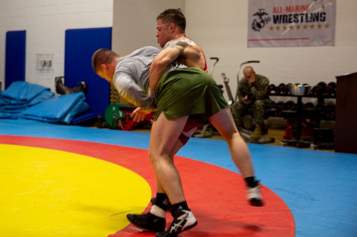 U.S. Marine Corps, Sgt. Joshua Medina, right, throws Pfc. Thomas Hicks, left, with the All-Marine Wrestling Team (AMWT), while practicing wrestling techniques to prepare for the Olympic Trials, on Marine Corps Air Station New River, North Carolina, Jan. 8, 2021. Members of the AMWT are preparing for the trials, scheduled for April 2021 at Penn State University, for a chance to represent the U.S. in the 2020 Olympics. (U.S. Marine Corps photo by Lance Cpl. Christian Ayers)