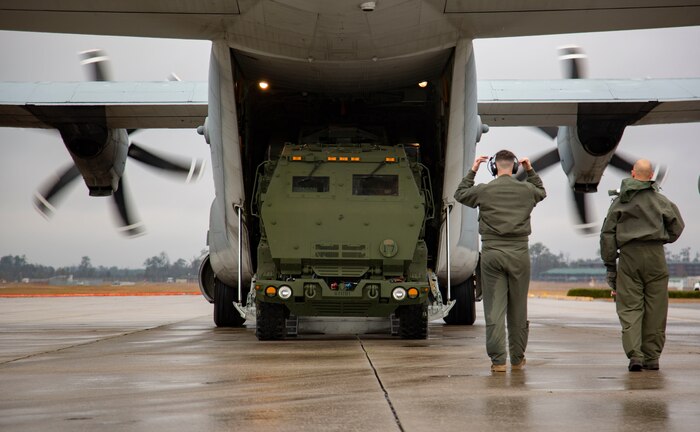 U.S. Marines guide a M142 High Mobility Artillery Rocket Systems from a Lockheed C-130 Hercules during training on Marine Corps Air Station New River, North Carolina, Jan. 26, 2020. MCAS New River provided training that included unloading M142 HIMARS from a Lockheed C-130. (U.S. Marine Corps photo by Cpl. Ginnie Lee)