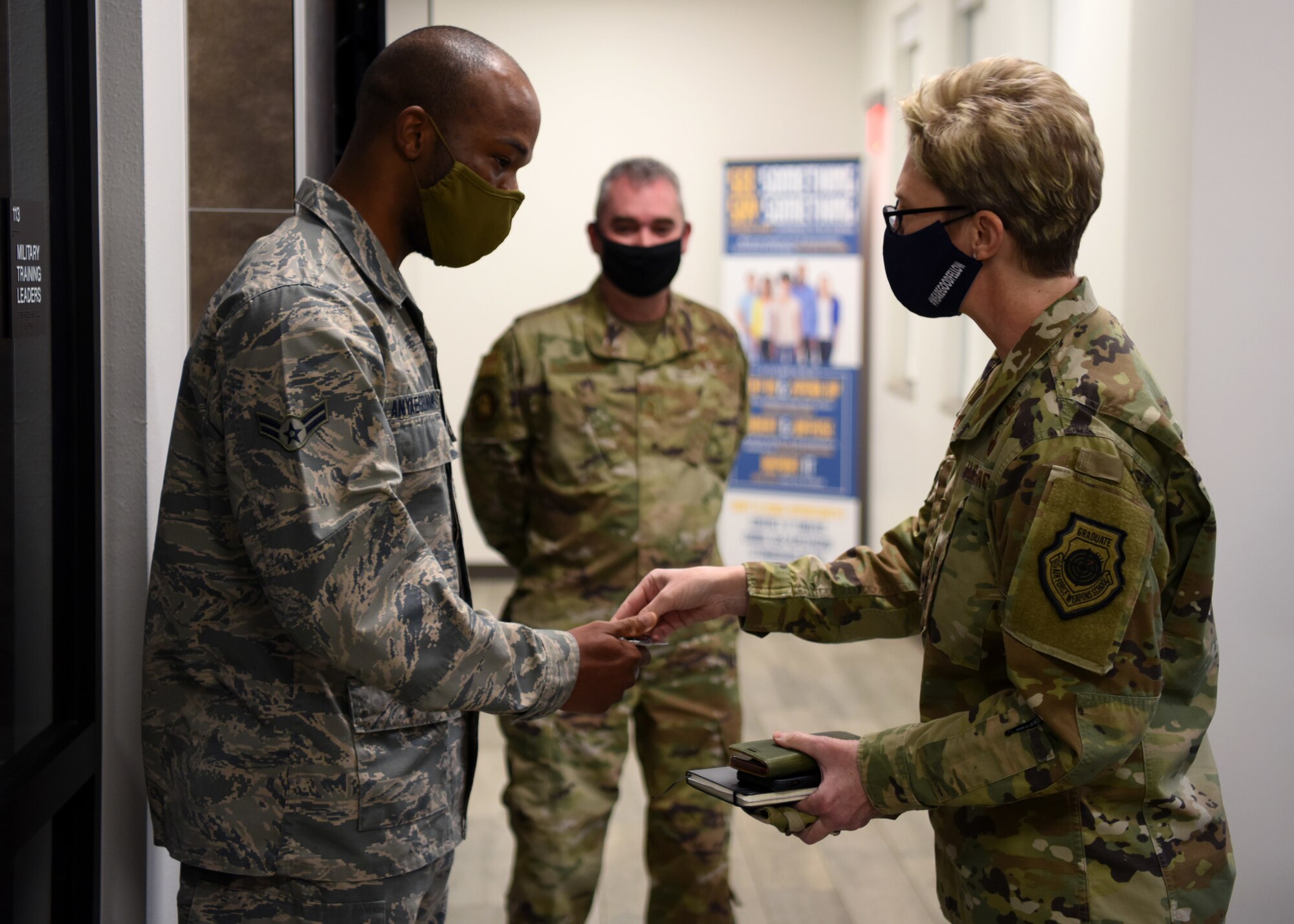 U.S. Air Force Maj. Gen. Leah Lauderback, director of Intelligence, Surveillance, and Reconnaissance, U.S. Space Force, coins Airman 1st Class Obinnamartine Anyaegbunam, 17th Force Support Squadron customer support technician, at the Cressman Dining Facility on Goodfellow Air Force Base, Texas, Jan. 26, 2021. Anyaegbunam was recognized for his exceptional work ethic in both his career field and volunteerism. Lauderback visited Goodfellow to interact with ISR professionals and learn how their training had evolved due to COVID. (U.S. Air Force photo by Airman 1st Class Ethan Sherwood)