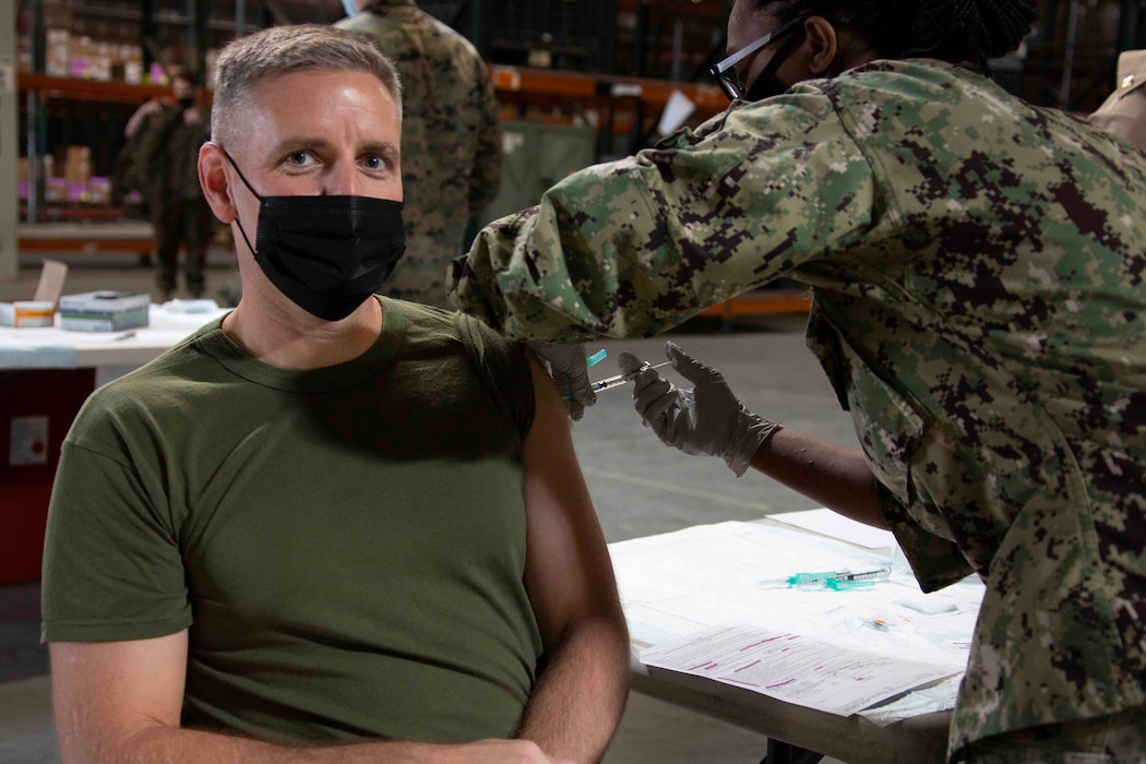 U.S. Marine Corps Lt. Col. Robert E. Herrmann, commanding officer for Marine Wing Headquarters Squadron 3, 3rd Marine Aircraft Wing, receives the COVID-19 vaccine on Marine Corps Air Station Miramar, California, Jan 29, 2021. Vaccines are being administered in a phased approach prioritizing health care workers and first responders as well as mission critical and deploying personnel.