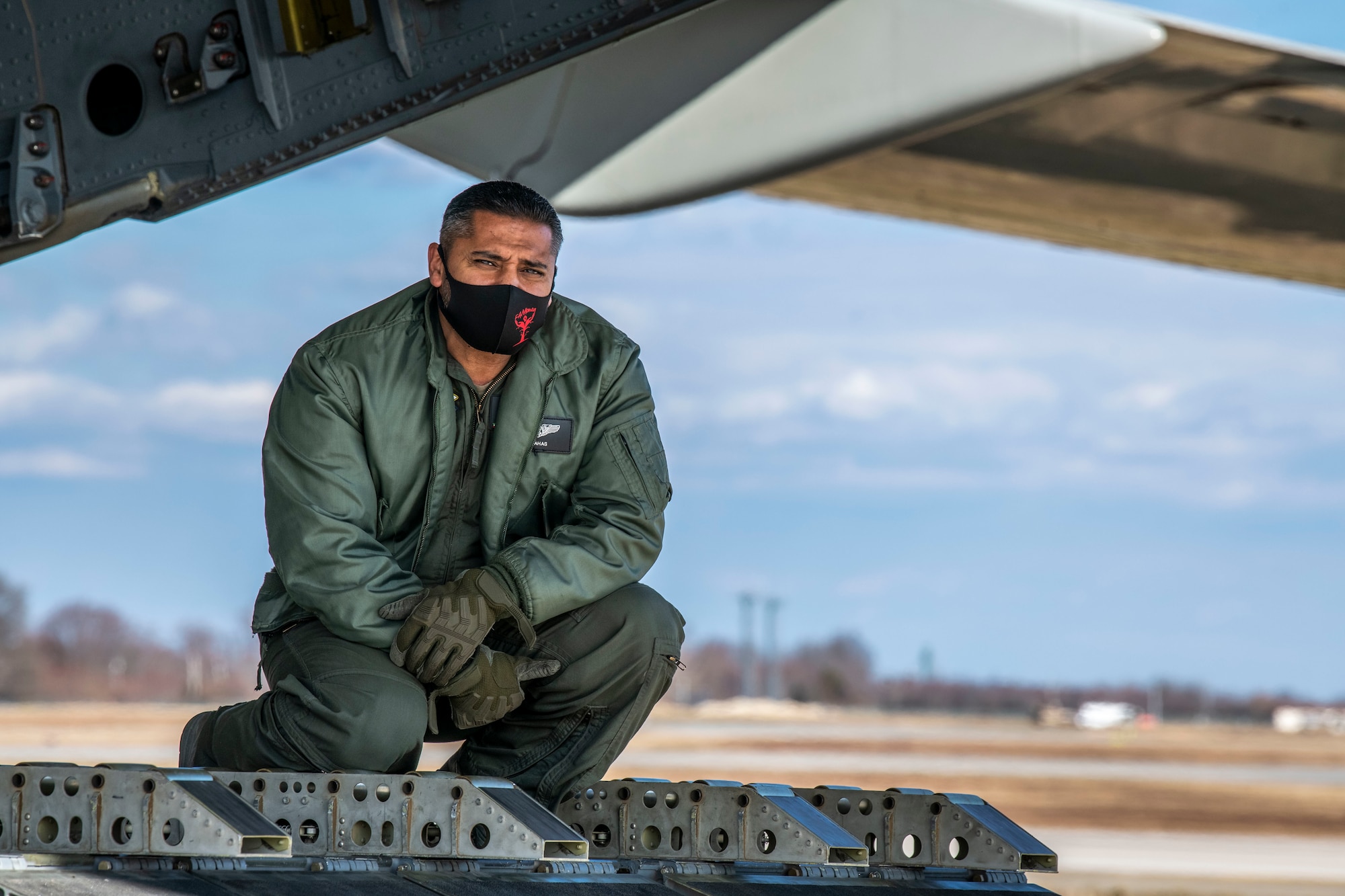 A Kuwait air force airman looks out of the ramp of a Kuwait air force C-17 Globemaster III at Dover Air Force Base, Delaware, Jan. 22, 2021. The U.S. strongly supports Kuwait’s sovereignty, security and independence as well as its multilateral diplomatic efforts to build greater cooperation in the region. Due to its strategic geographic location, Dover AFB supports approximately $3.5 billion worth of foreign military sales operations annually. (U.S. Air Force photo by Senior Airman Christopher Quail)