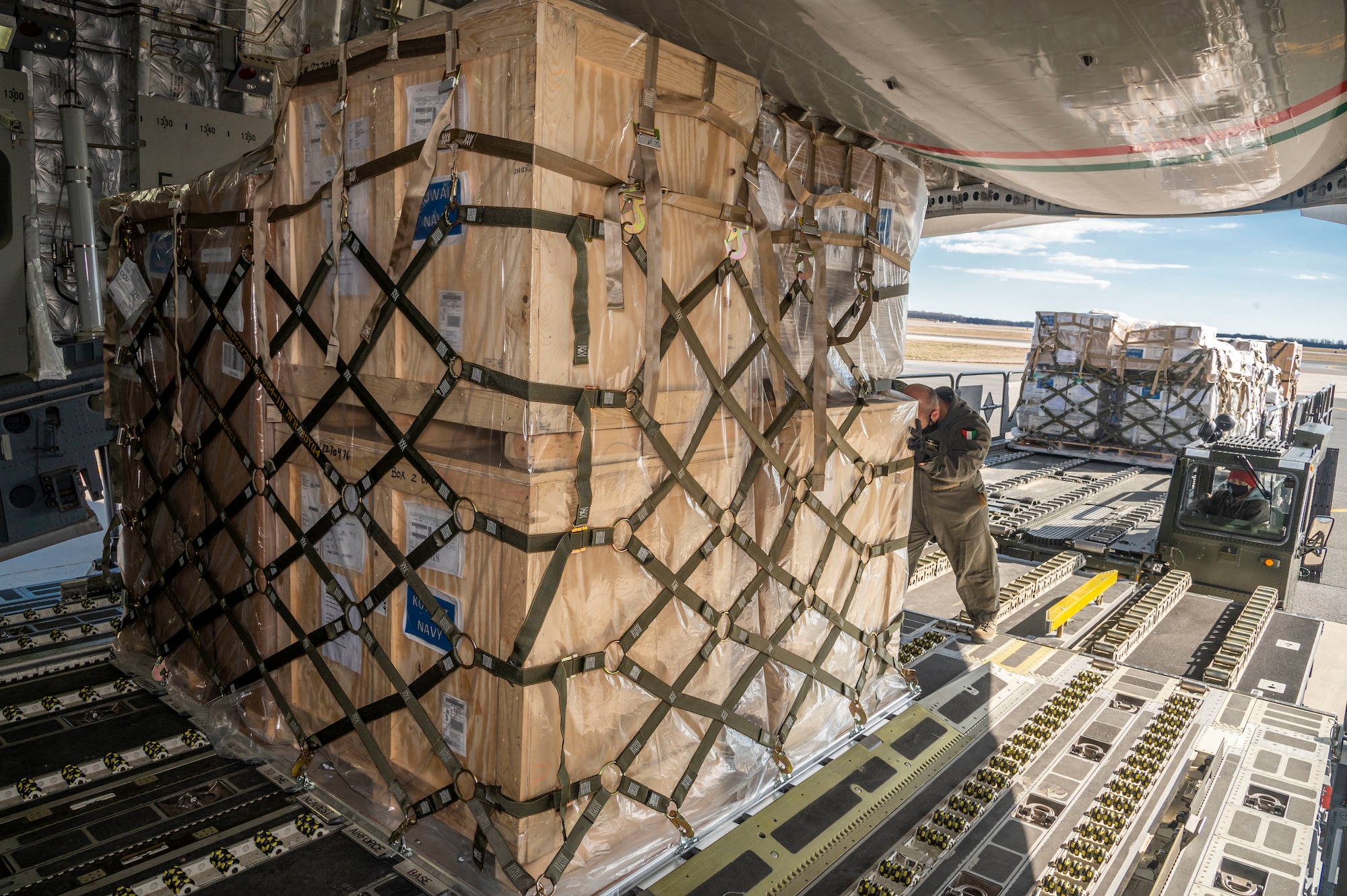 A Kuwait air force airman moves cargo onto a Kuwait air force C-17 Globemaster III at Dover Air Force Base, Delaware, Jan. 22, 2021. Kuwait is an important partner in U.S. counterterrorism efforts, providing assistance in the military, diplomatic, and intelligence arenas and also supporting efforts to block financing of terrorist groups. Due to its strategic geographic location, Dover AFB supports approximately $3.5 billion worth of foreign military sales operations annually. (U.S. Air Force photo by Senior Airman Christopher Quail)