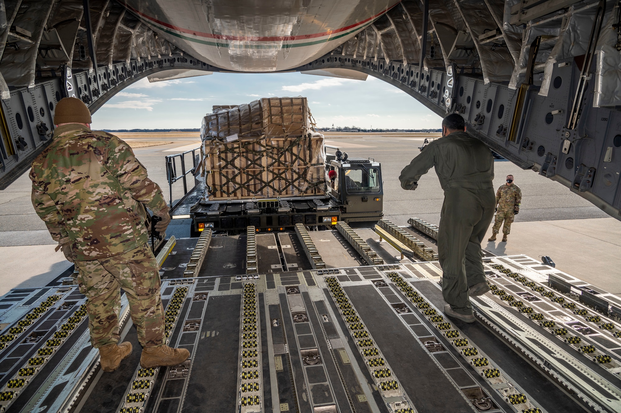 A Kuwait air force airman guides a K-loader onto the ramp of a Kuwait air force C-17 Globemaster III at Dover Air Force Base, Delaware, Jan. 22, 2021. Kuwait is an important partner in U.S. counterterrorism efforts, providing assistance in the military, diplomatic, and intelligence arenas and also supporting efforts to block financing of terrorist groups. Due to its strategic geographic location, Dover AFB supports approximately $3.5 billion worth of foreign military sales operations annually. (U.S. Air Force photo by Senior Airman Christopher Quail)