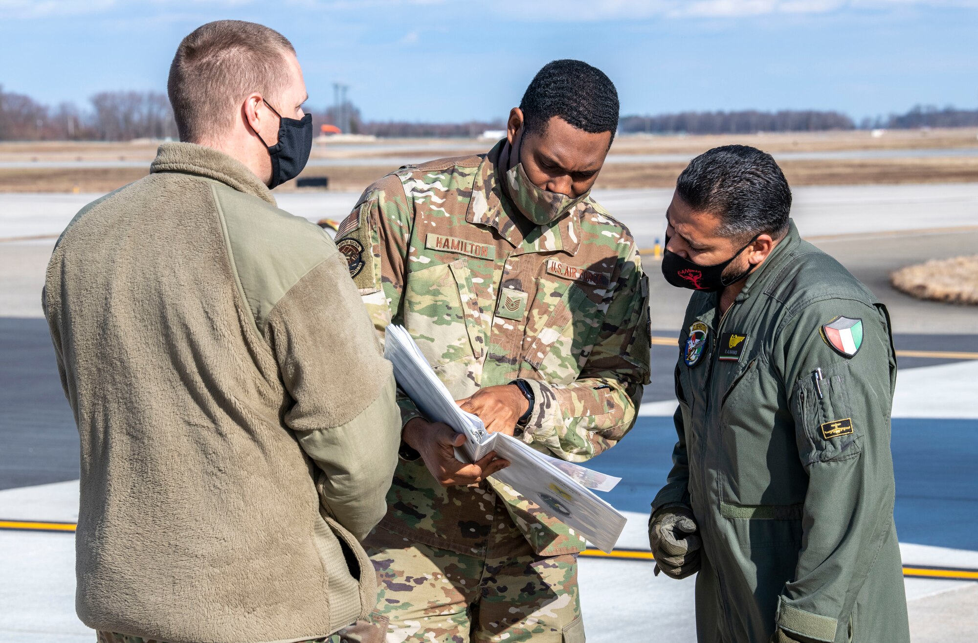 Tech. Sgt. Ishmael Hamilton, 436th Logistics Readiness Squadron ground transportation support noncommissioned officer in charge, speaks with a Kuwait air force airman at Dover Air Force Base, Delaware, Jan. 22, 2021. The U.S. strongly supports Kuwait’s sovereignty, security and independence as well as its multilateral diplomatic efforts to build greater cooperation in the region. Due to its strategic geographic location, Dover AFB supports approximately $3.5 billion worth of foreign military sales operations annually. (U.S. Air Force photo by Senior Airman Christopher Quail)