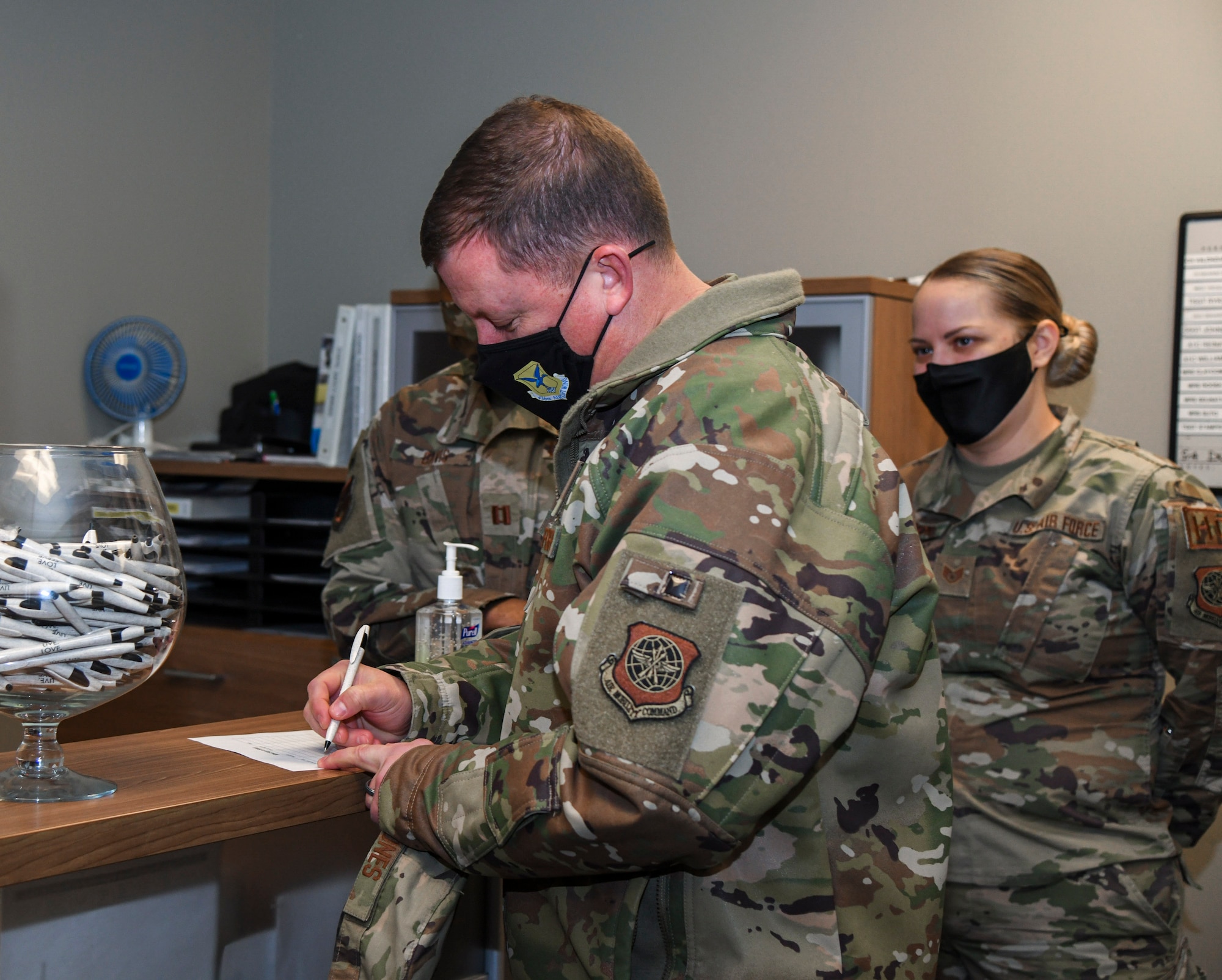 Col. Matthew Jones, 436th Airlift Wing commander, signs a visitor log during a relaxation room grand opening at Chapel 1 on Dover Air Force Base, Delaware, Jan. 21, 2021. Designed by the 436th AW chapel team, the relaxation room affords Airmen a quiet, inviting  space to relax and cultivate their spiritual and mental resilience. The room can hold up to four people at a time on a first-come, first-served basis during normal chapel operating hours. (U.S. Air Force photo by Airman 1st Class Stephani Barge)