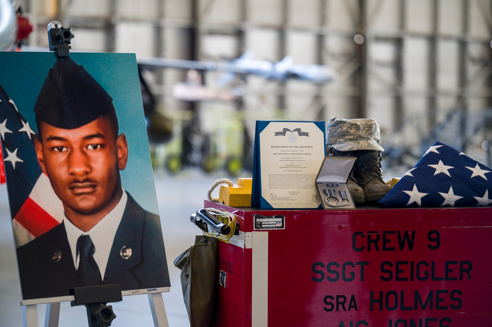 Airmen from 412th Maintenance Squadron held a memorial ceremony for Senior Airman Robert Holmes, Jr., at Edwards Air Force Base, California, Jan. 29. Holmes was assigned to the 416th Aircraft Maintenance Unit Weapons Section, where he worked as a weapons load crew team member on a fleet of 25 F-16 Fighting Falcons. Holmes was  awarded Air Force Achievement Medal posthumously. (Air Force photo by Giancarlo Casem)