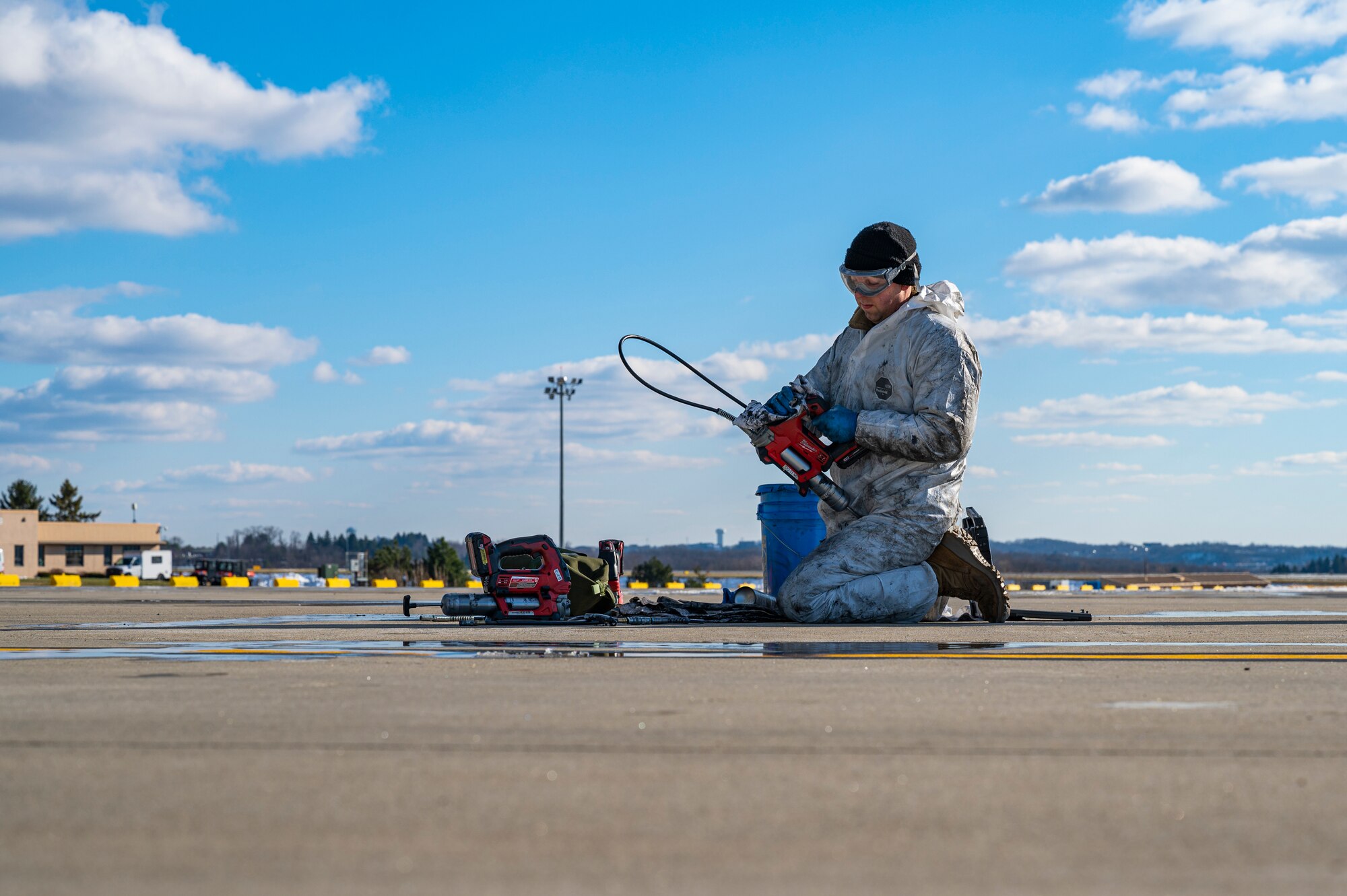Tech. Sgt. Jeffrey Raymond, 911th Aircraft Maintenance Squadron crew chief, cleans a grease gun on the flight line at the Pittsburgh International Airport Air Reserve Station, Pennsylvania, Dec. 29, 2020.