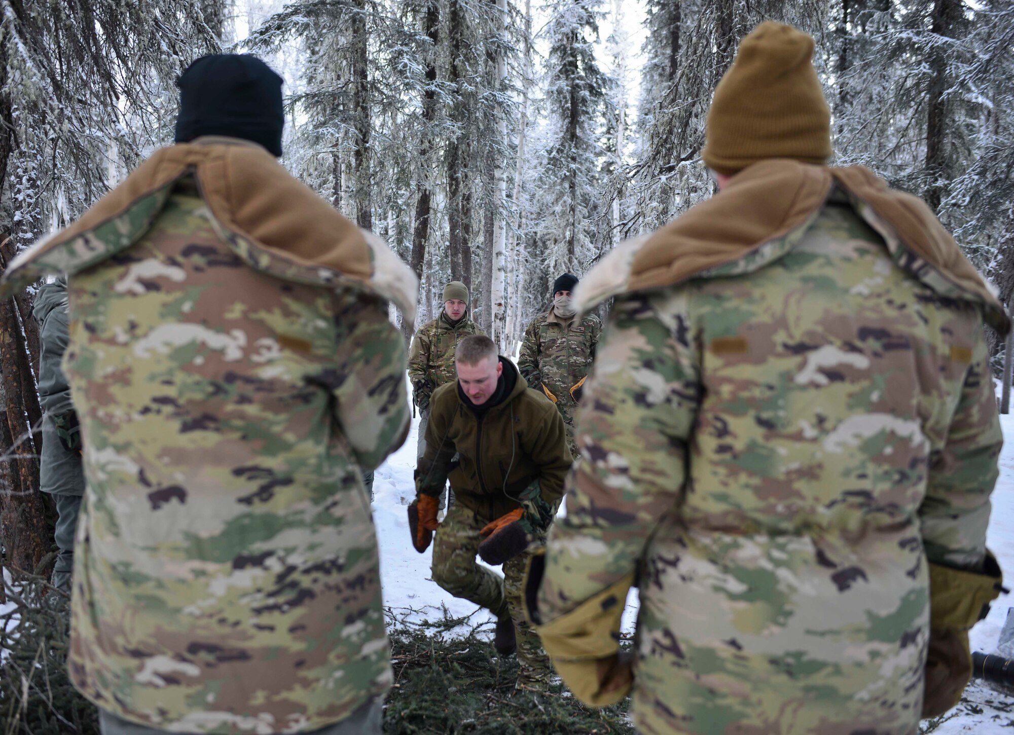 U.S. Air Force Staff Sgt. Samuel Ley, a Survival, Evasion, Resistance and Escape specialist assigned to the Arctic Survival Training School, demonstrates how to set up a thermalized A-frame survival shelter on Eielson Air Force Base, Alaska, Jan. 27, 2021.