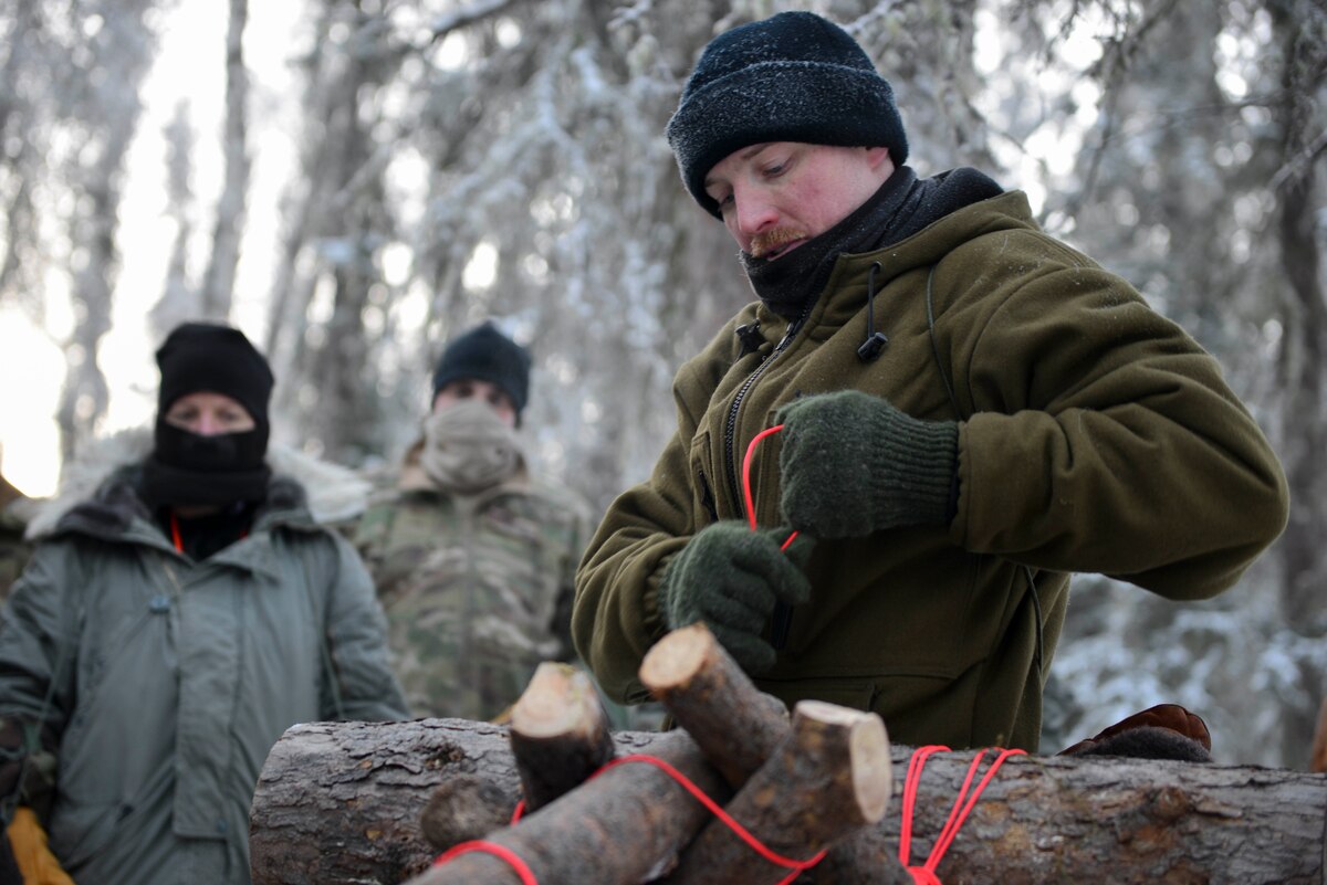 U.S. Air Force Staff Sgt. Samuel Ley, a Survival, Evasion, Resistance and Escape specialist assigned to the Arctic Survival Training School, demonstrates how to set up a thermalized A-frame survival shelter on Eielson Air Force Base, Alaska, Jan. 27, 2021.
