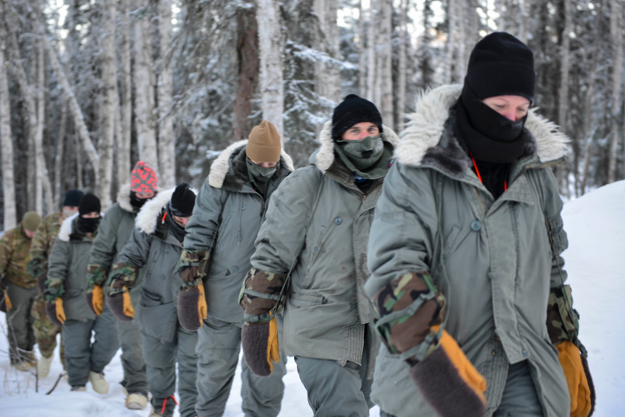 Arctic Survival Training students rally back to their shelters on Eielson Air Force Base, Alaska, Jan. 27, 2021.