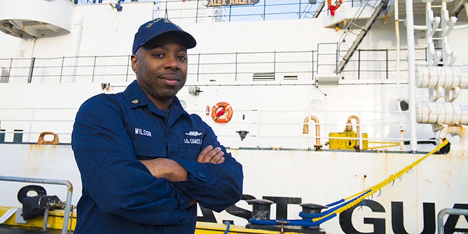 Chief Petty Officer Spencer Wilson pauses for a photo by Coast Guard Cutter Alex Haley in Kodiak, Alaska, Feb. 13, 2015. Wilson, a damage controlman aboard the cutter, is a passionate believer in celebrating the positive influences and traditions that African Americans enrich our nation with. (U.S. Coast Guard photo by Petty Officer 2nd Class Diana Honings)