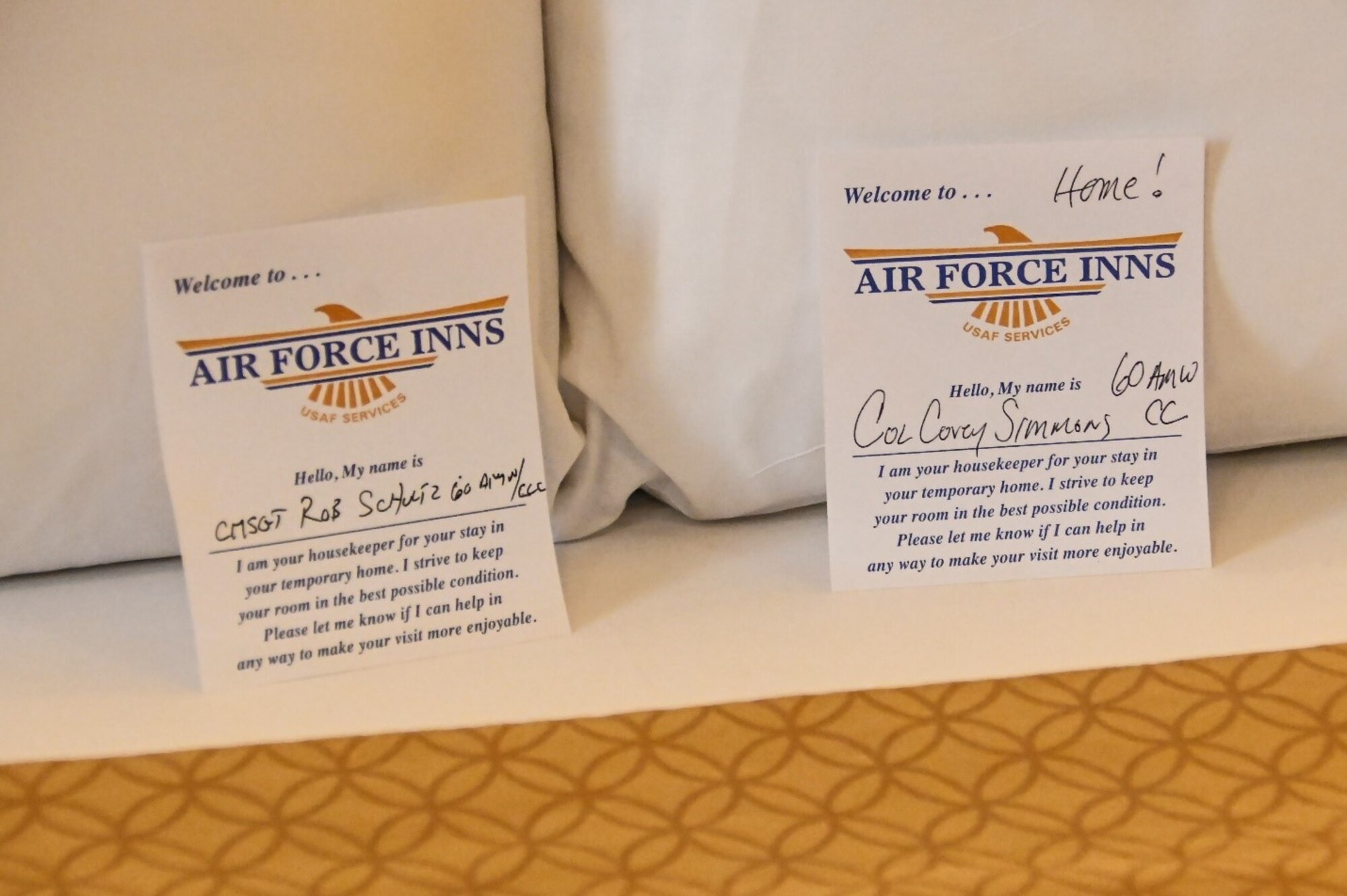 Two welcome cards signed by U.S. Air Force Col. Corey Simmons, 60th Air Mobility Wing commander, and Chief Master Sgt. Robert Schultz, 60th AMW command chief, lie on a bed at the Westwind Inn at Travis Air Force Base, California, Jan. 29, 2021. Simmons and Schultz’s visit to the hotel was part of the Leadership Rounds program, which provides 60th AMW leadership an opportunity to interact with Airmen and receive a detailed view of each mission performed at Travis AFB. (U.S. Air Force photo by Senior Airman Christian Conrad)