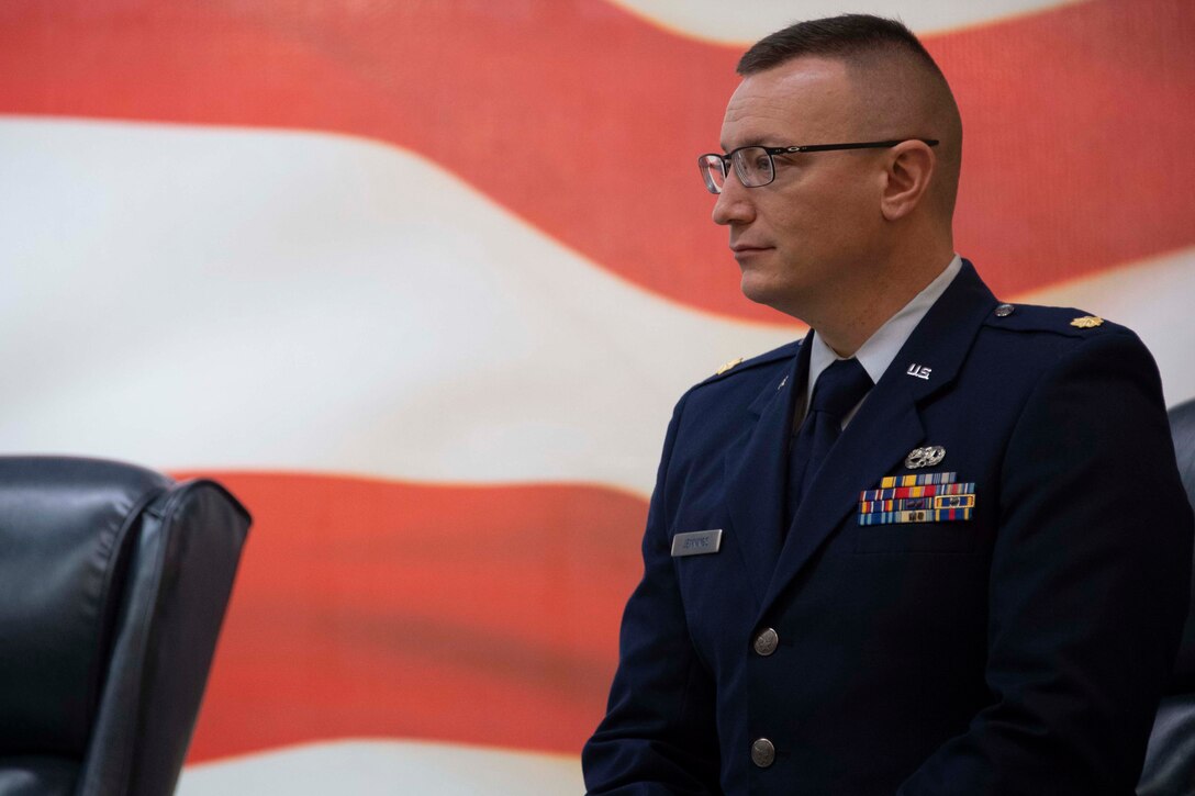Photo of Airman with U.S. flag in background