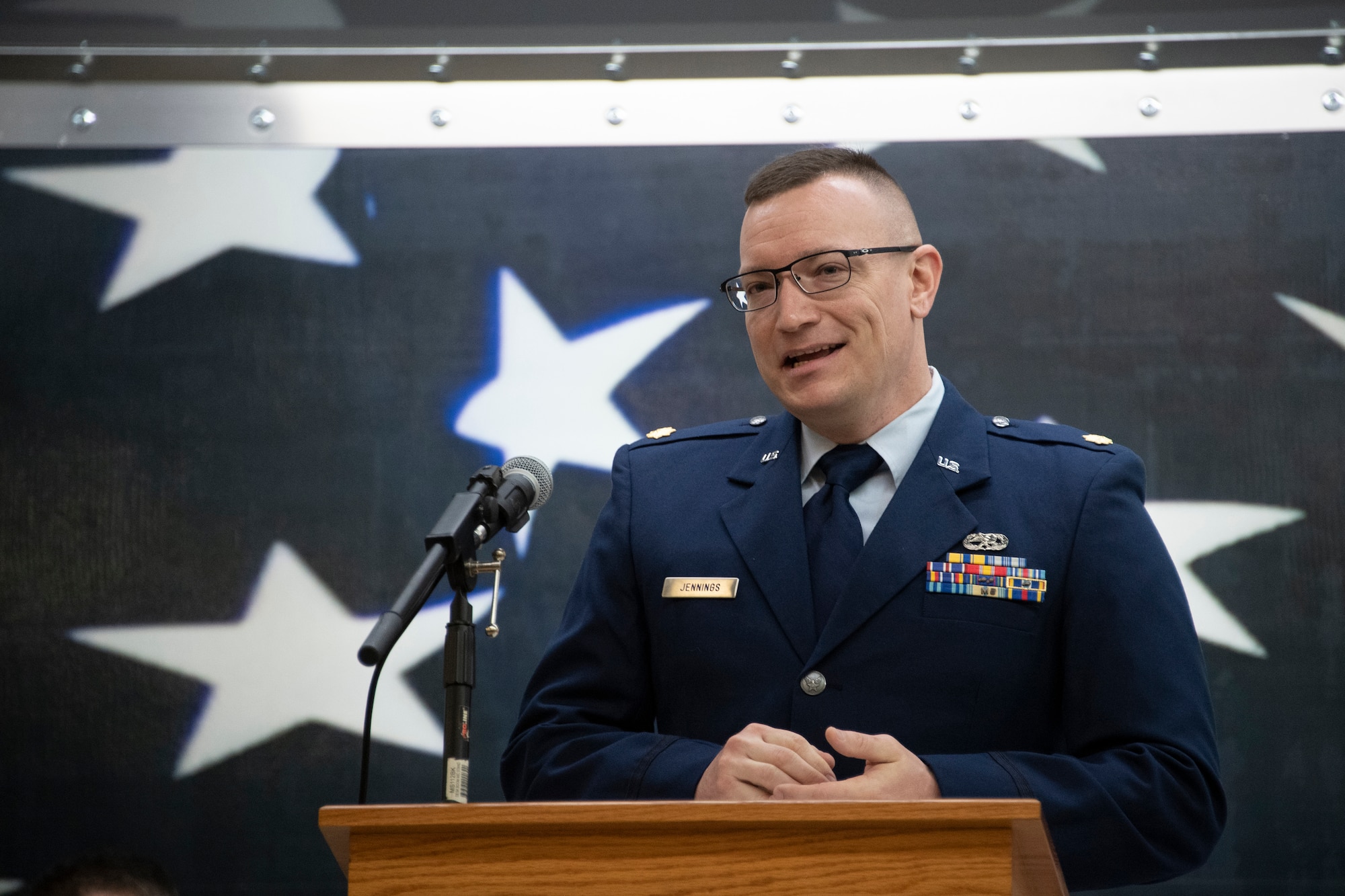 Photo of airman speaking at podium