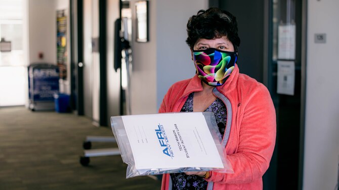 A homeschool parent picks up a STEM Tech Mission packet for her student. (U.S. Air Force photo/Macee Hunt)