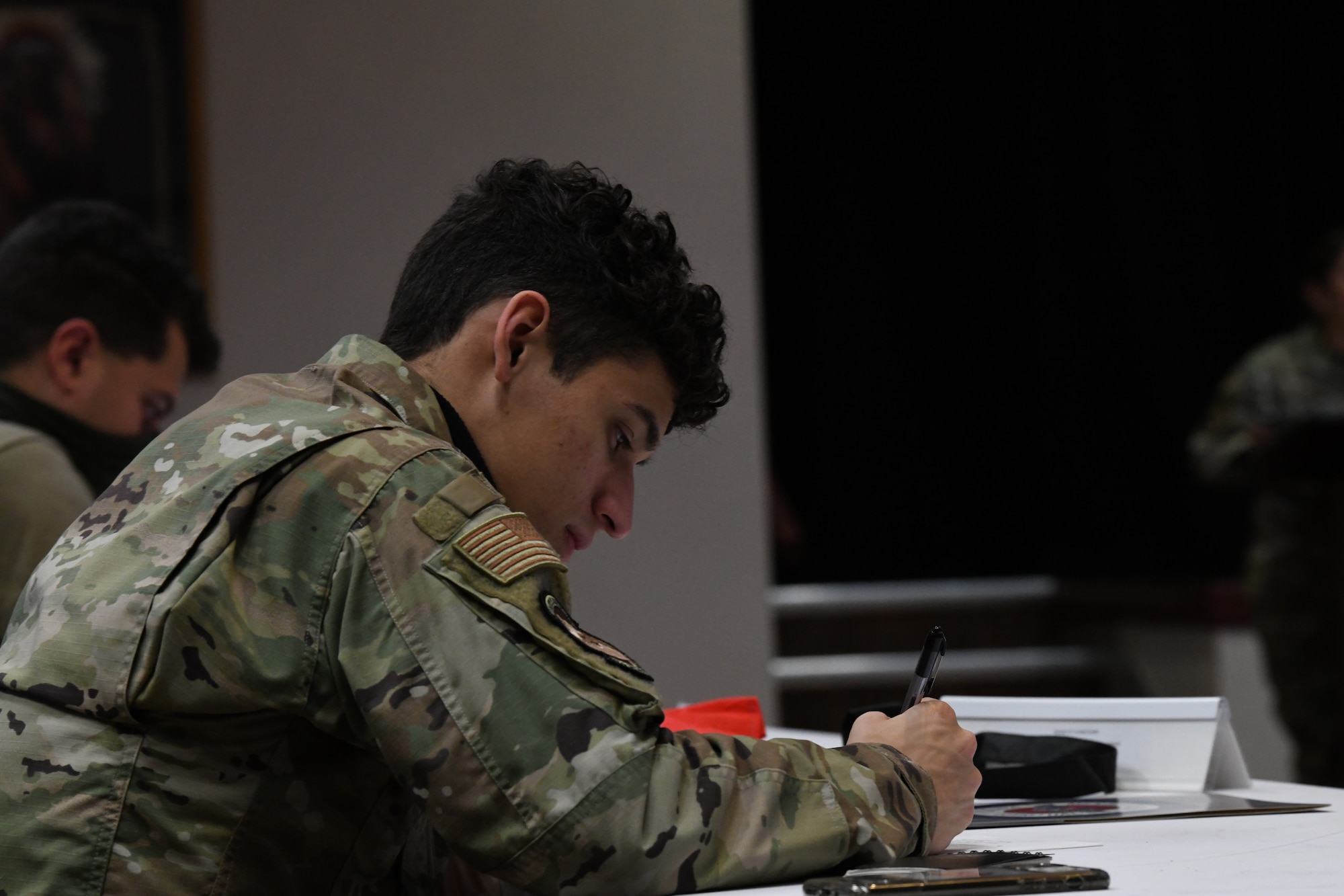 person writing at a desk