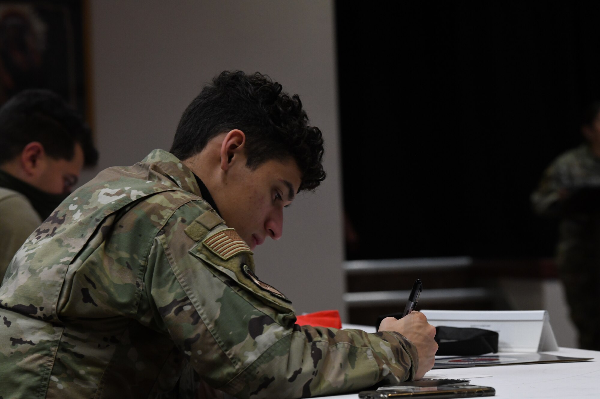 person writing at a desk