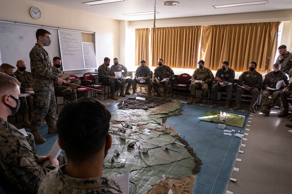 U.S. Marine Corps, Army and Air Force military members discuss mission operations for Joint Exercise Littoral Strike at Combined Arms Training Center Camp Fuji, Japan, Jan. 20, 2021.