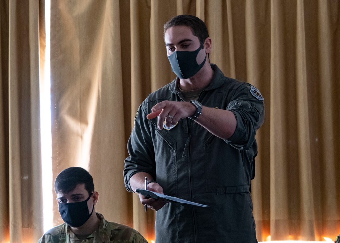 U.S. Air Force Capt. Bernie Cox, 36th Airlift Squadron C-130J Super Hercules pilot, discusses mission operations for Joint Exercise Littoral Strike at Combined Arms Training Center Camp Fuji, Japan, Jan. 20, 2021.