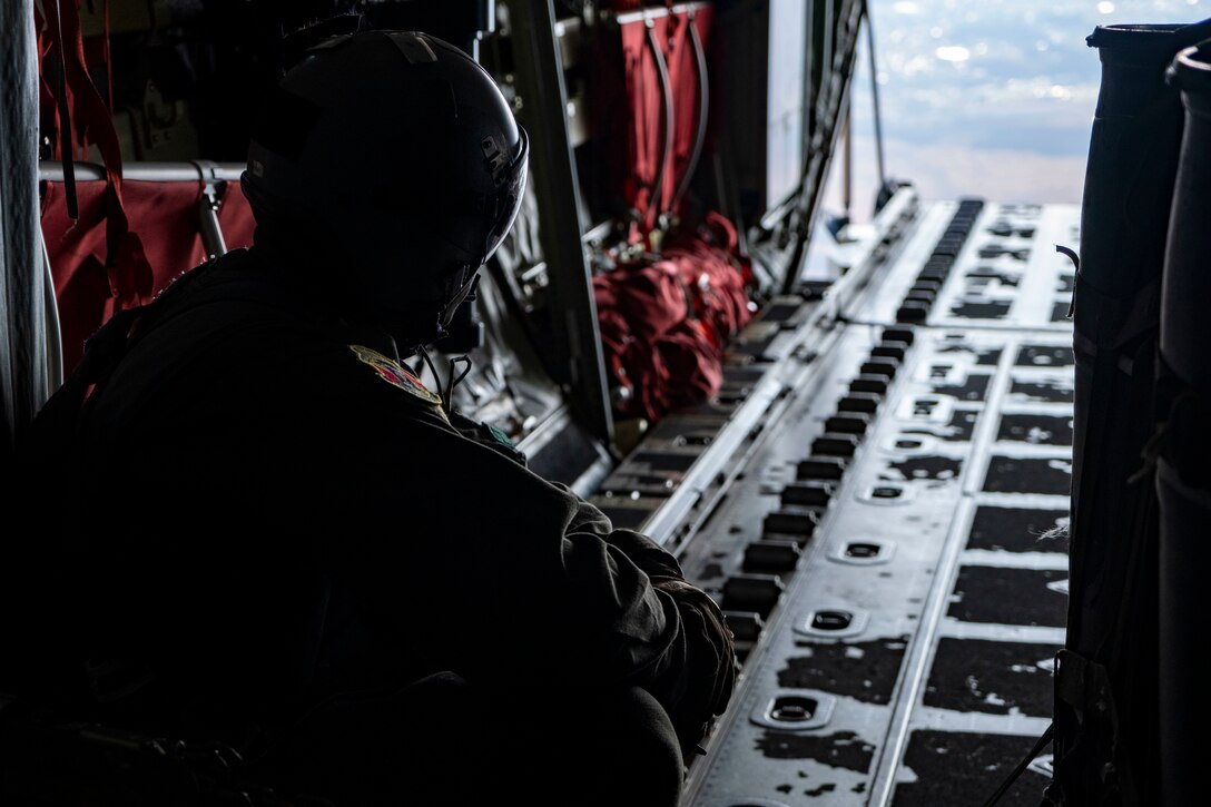 Tech. Sgt. Brian Gates, 36th Airlift Squadron loadmaster, waits for the green light to release a container delivery system from a C-130J Super Hercules near Combined Arms Training Center Camp Fuji, Japan, Jan. 22, 2021.