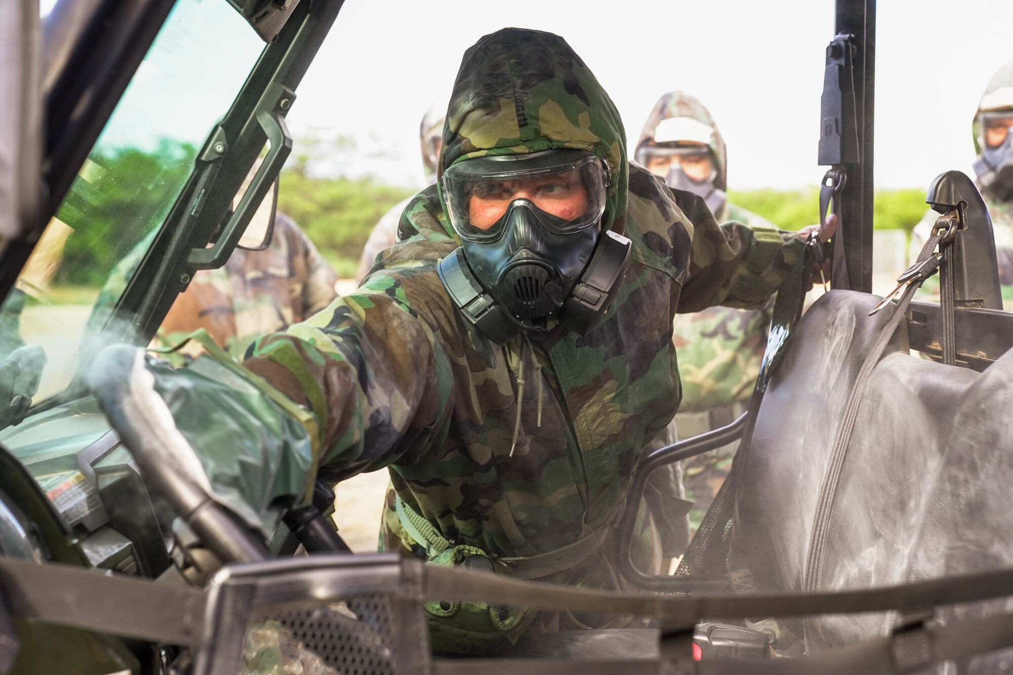 Senior Airman Jacob Chackel-Edwards, 15th Maintenance Squadron aerospace propulsion mechanic, decontaminates an all-terrain vehicle during a chemical, biological, radioactive, and nuclear training on Joint Base Pearl Harbor-Hickam, Hawaii, Jan. 21, 2021. Decontamination training is essential in teaching Airmen the importance of decontaminating equipment and themselves to stay mission ready. (U.S. photo by Airman 1st Class Makensie Cooper)