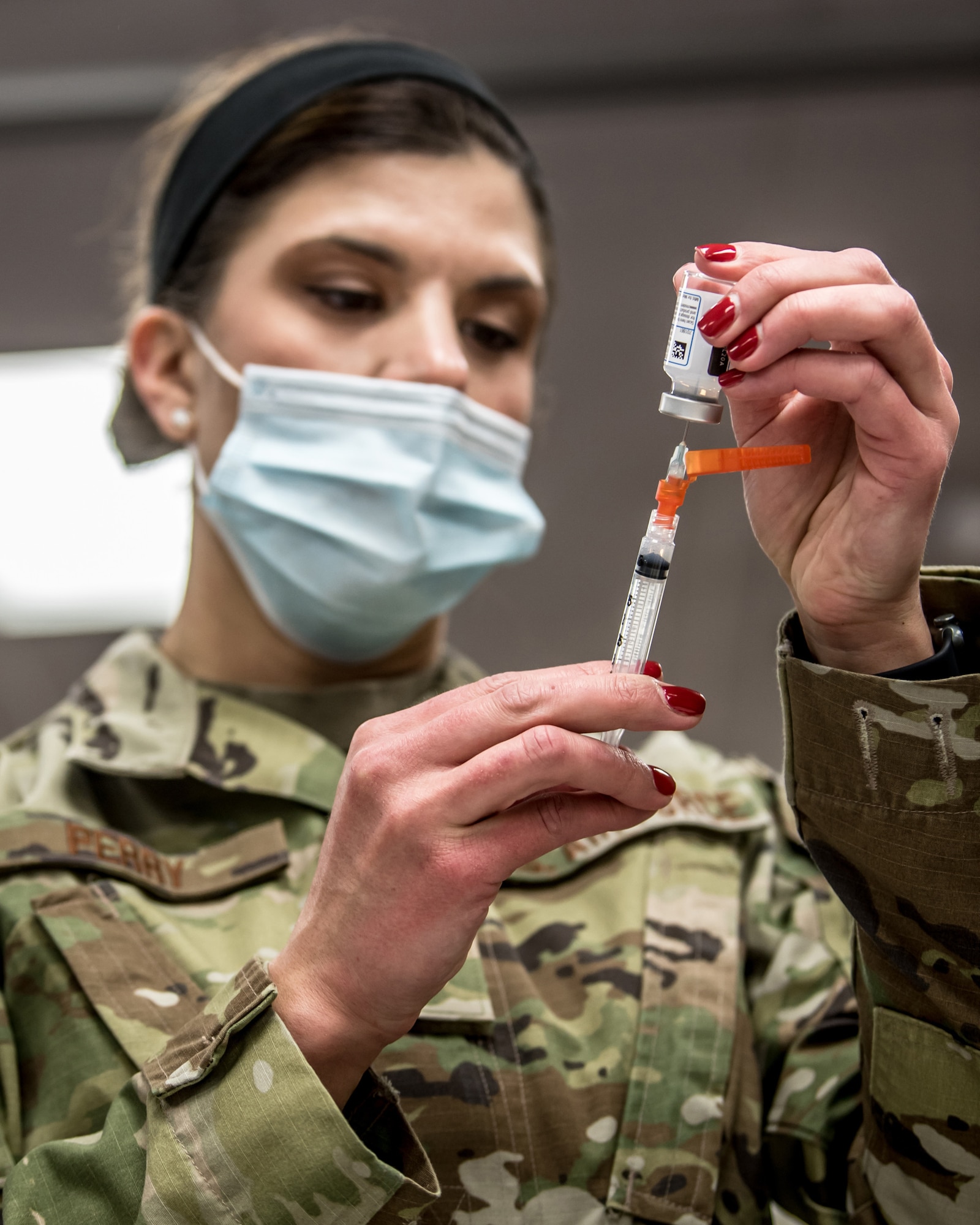 Master Sgt. Natasha Perry, a medic with the 123rd Medical Group, prepares to administer a COVID-19 vaccination to members of the 123rd Airlift Wing at the Kentucky Air National Guard Base in Louisville Ky., Jan. 9, 2021.