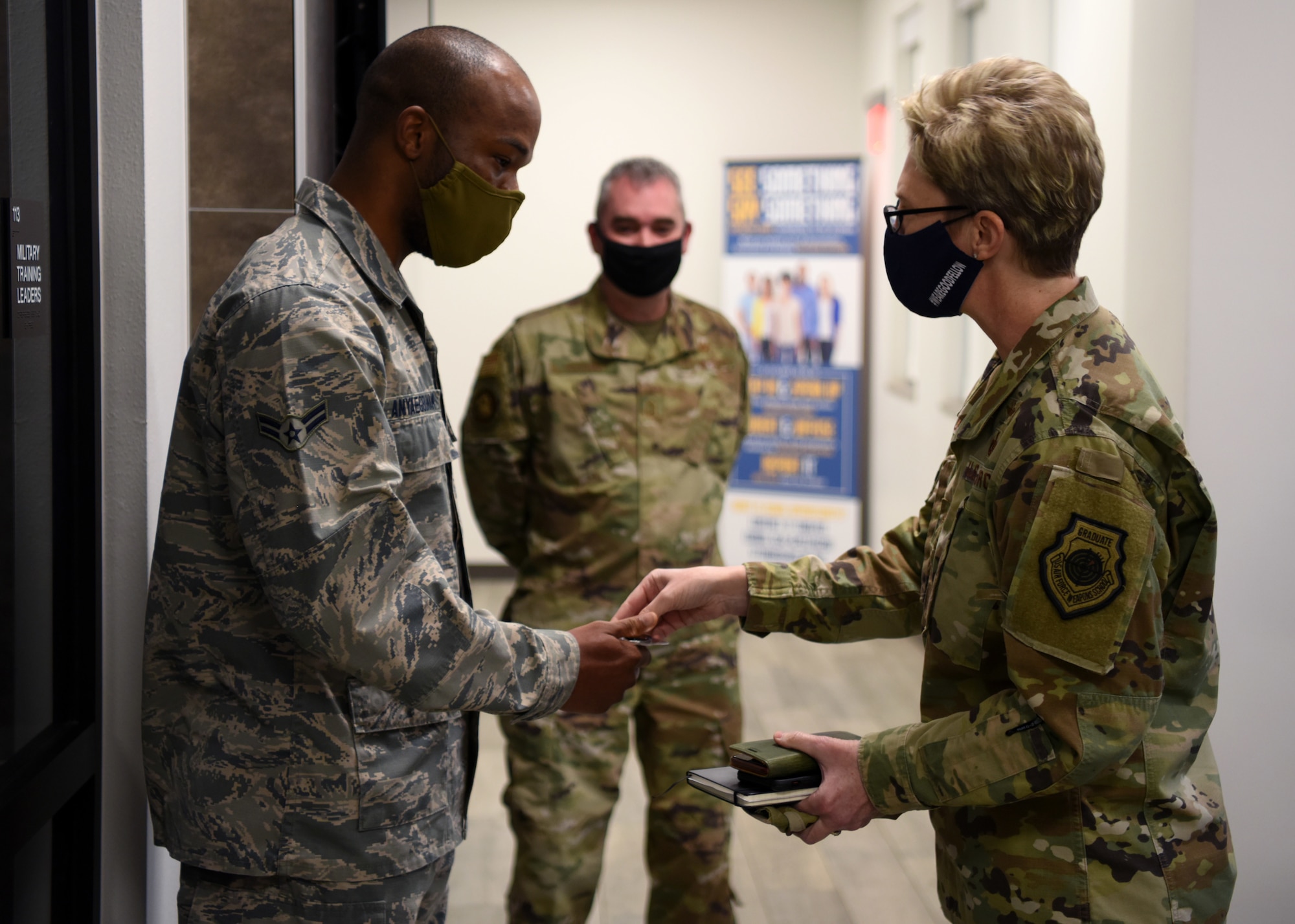 U.S. Air Force Maj. Gen. Leah Lauderback, director of Intelligence, Surveillance, and Reconnaissance, U.S. Space Force, coins Airman 1st Class Obinnamartine Anyaegbunam, 17th Force Support Squadron customer support technician, at the Cressman Dining Facility on Goodfellow Air Force Base, Texas, Jan. 26, 2021. Anyaegbunam was recognized for his exceptional work ethic in both his career field and volunteerism. Lauderback visited Goodfellow to interact with ISR professionals and learn how their training had evolved due to COVID. (U.S. Air Force photo by Airman 1st Class Ethan Sherwood)