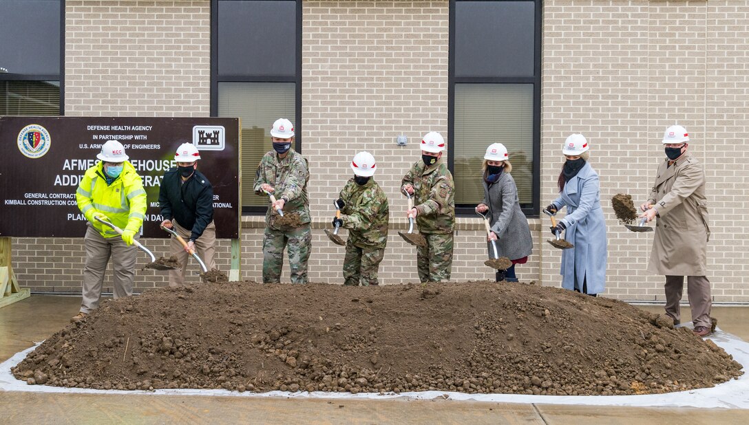 From left to right, Kurk Walton, Kimball Construction Company chief operating officer; Cmdr. Scott Rossi, Defense Health Agency chief of design, construction and activation; Lt. Col. David Park, U.S. Army Corps of Engineers Philadelphia District commander; Col. Alice Briones, Armed Force Medical Examiner System director; Col. Matthew Jones, 436th Airlift Wing commander; Kate Rohrer, representative for U.S. Senator Chris Coons; Lauren Gutierrez, representative for U.S. Senator Thomas Carper; and Mark Vojtecky, AFMES chief of staff, break ground Jan. 26, 2021, at Armed Forces Medical Examiner System, on Dover Air Force Base, Delaware. AFMES held a groundbreaking ceremony for a warehouse addition and alteration to the existing AFMES building. The 2,500 square foot warehouse addition will increase AFMES’ storage capabilities and renovation of the existing 3,300 square foot logistics general storage warehouse will make it a more functional and efficient warehouse space. (U.S. Air Force photo by Roland Balik)