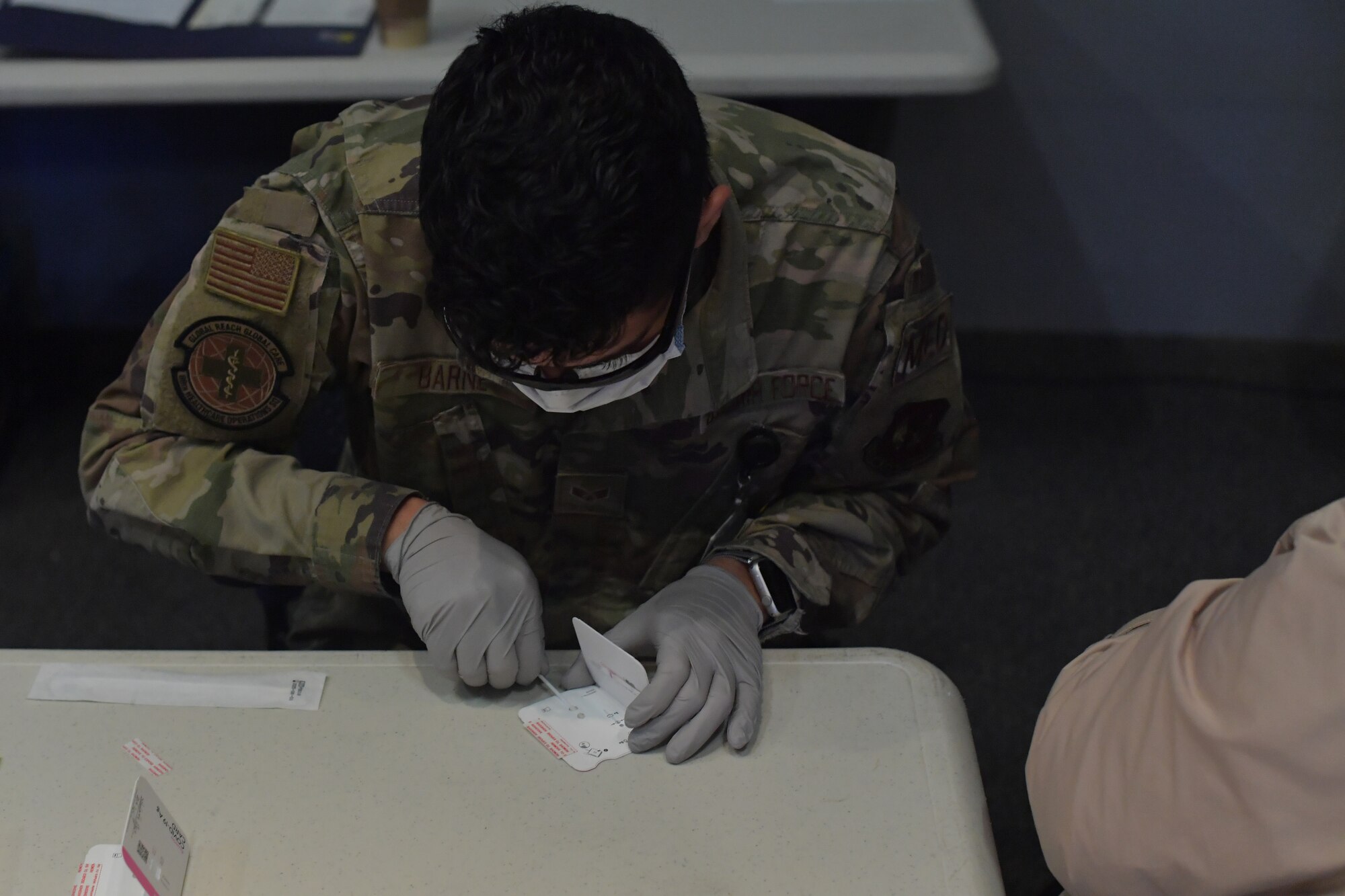 U.S. Air Force Senior Airman Marquis Barney, 86th Healthcare Operations Squadron medical technician, conducts a pre-travel COVID-19 test at the Enlisted Club on Ramstein Air Base, Germany, Jan. 28, 2021.