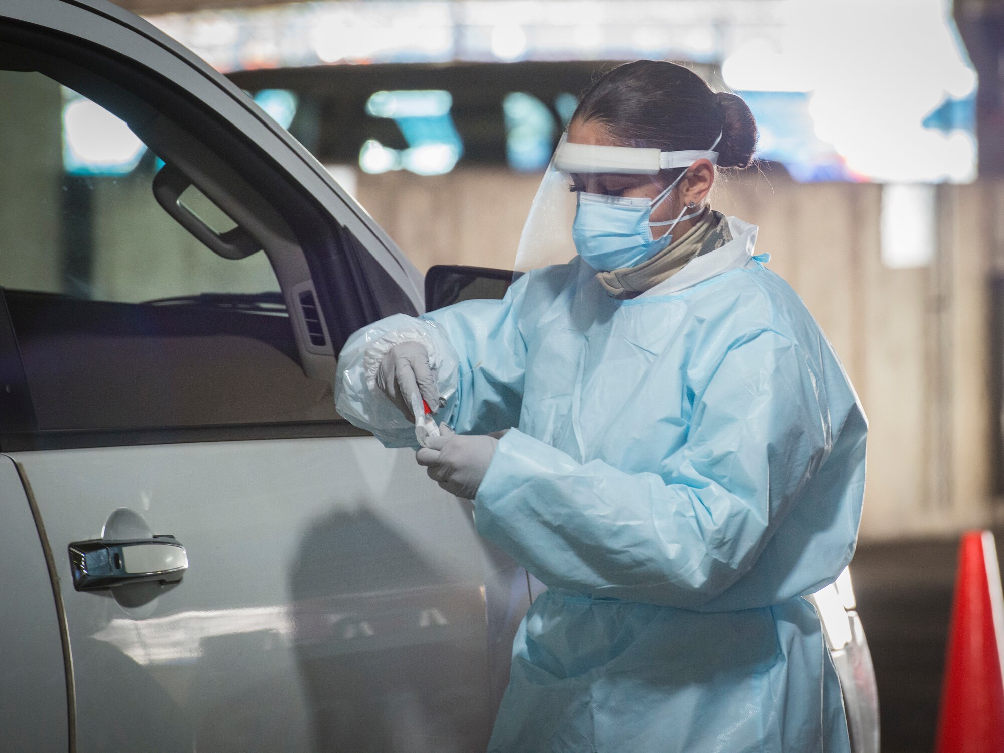 Airman 1st Class Crisbel Burgos, 103rd Force Support Squadron services specialist, collects a swab sample at a COVID-19 testing site at Yale New Haven Hospital Saint Raphael Campus in New Haven, Connecticut, Dec. 4, 2020. 150 Connecticut National Guard Airmen are supporting several COVID-19 response missions throughout the state, including 27 COVID-19 testing sites and two food distribution sites. (U.S. Air National Guard photo by Staff Sgt. Steven Tucker)